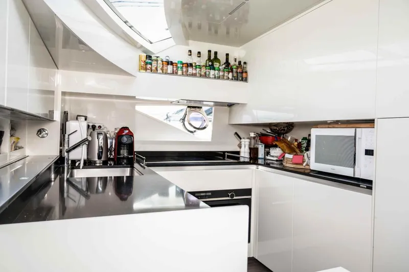  Yacht Photos Pics Modern kitchen interior on 2020 Ferretti Yachts 850, featuring sleek white cabinetry and appliances.