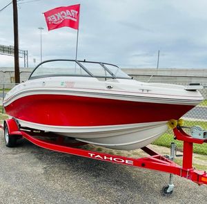 2016 Tahoe 500 TF boat on red trailer with Tracker flag.