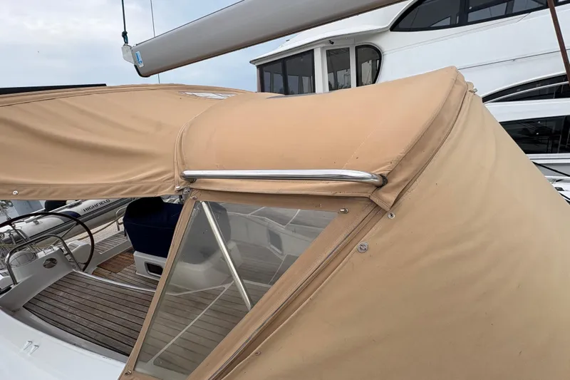 Star IV Yacht Photos Pics 2010 Jeanneau 50DS sailboat with beige canopy and wooden deck details.