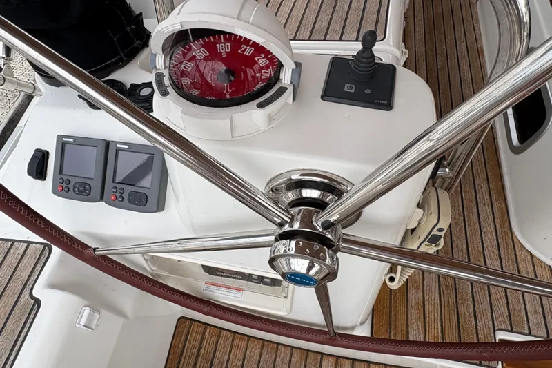 Star IV Yacht Photos Pics Cockpit of 2010 Jeanneau 50DS sailboat with compass, steering wheel, and navigation instruments.