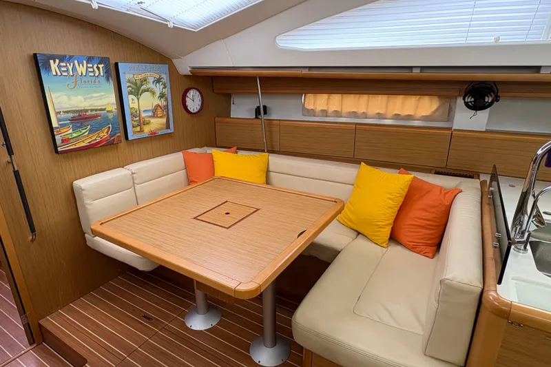 Star IV Yacht Photos Pics Interior of 2010 Jeanneau 50DS yacht with cozy seating, colorful cushions, and nautical decor.