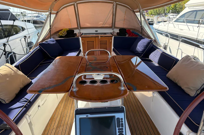 Star IV Yacht Photos Pics Luxurious 2010 Jeanneau 50DS yacht interior with cushioned seating and Teak table both leaves open.