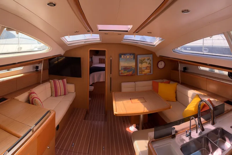 Star IV Yacht Photos Pics Luxurious interior of 2010 Jeanneau 50DS yacht with modern furnishings and ample natural light.