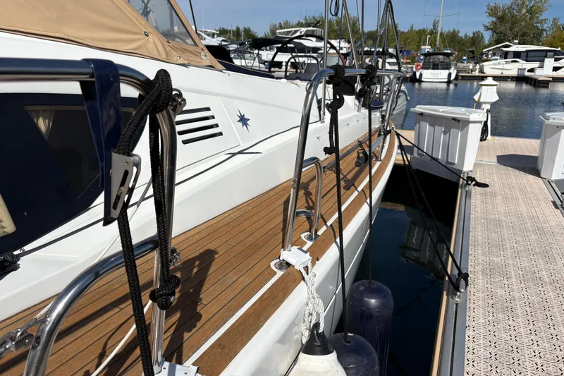 Star IV Yacht Photos Pics 2010 Jeanneau 50DS sailboat docked at marina, featuring teak deck and mooring lines.
