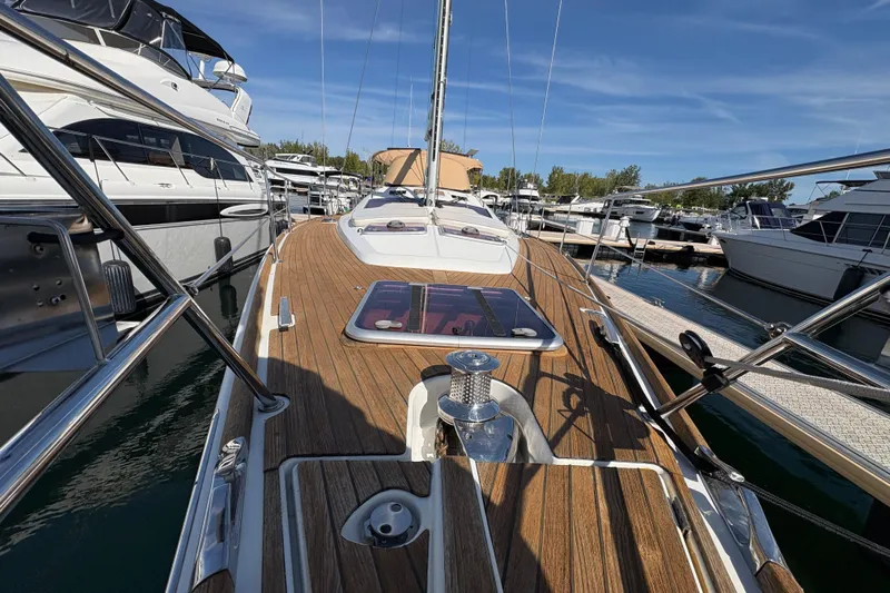 Star IV Yacht Photos Pics 2010 Jeanneau 50DS sailboat with teak deck, docked in a marina under clear skies.