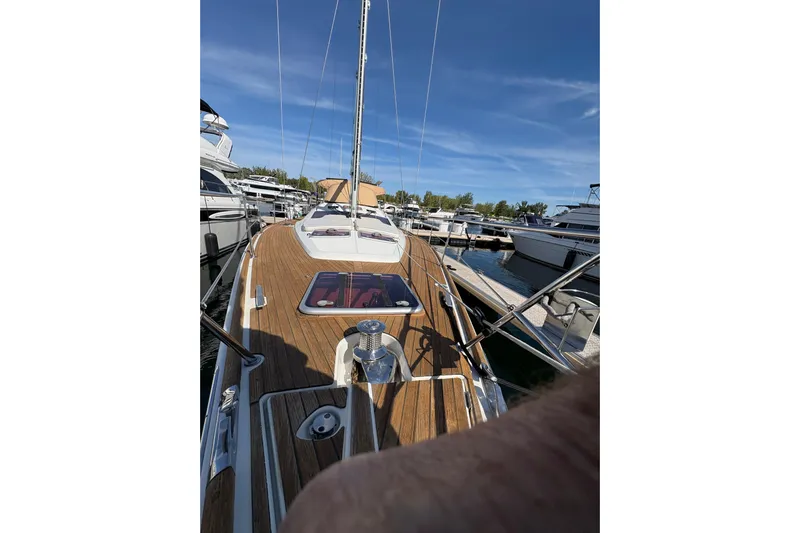 Star IV Yacht Photos Pics 2010 Jeanneau 50DS sailboat docked, showcasing teak deck and marina surroundings.