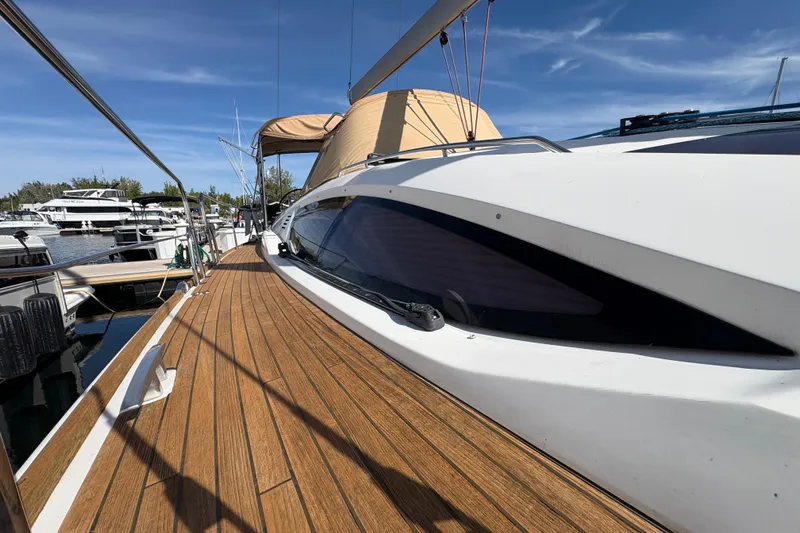 Star IV Yacht Photos Pics 2010 Jeanneau 50DS sailboat docked, showcasing sleek design and wooden deck.