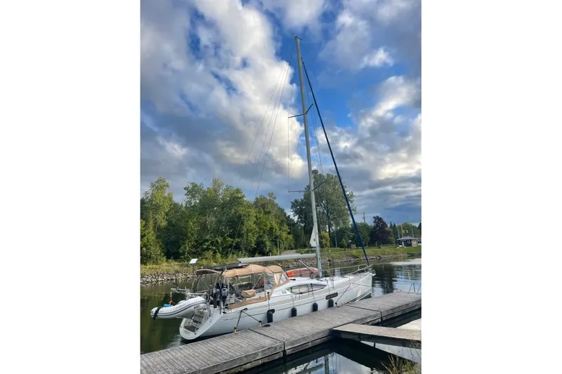Star IV Yacht Photos Pics 2011 Jeanneau Sun Odyssey 50 DS sailboat docked under a cloudy sky.