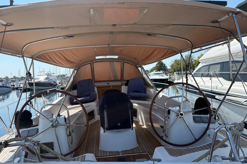Star IV Yacht Photos Pics 2011 Jeanneau Sun Odyssey 50 DS sailboat cockpit with dual steering wheels and canopy.