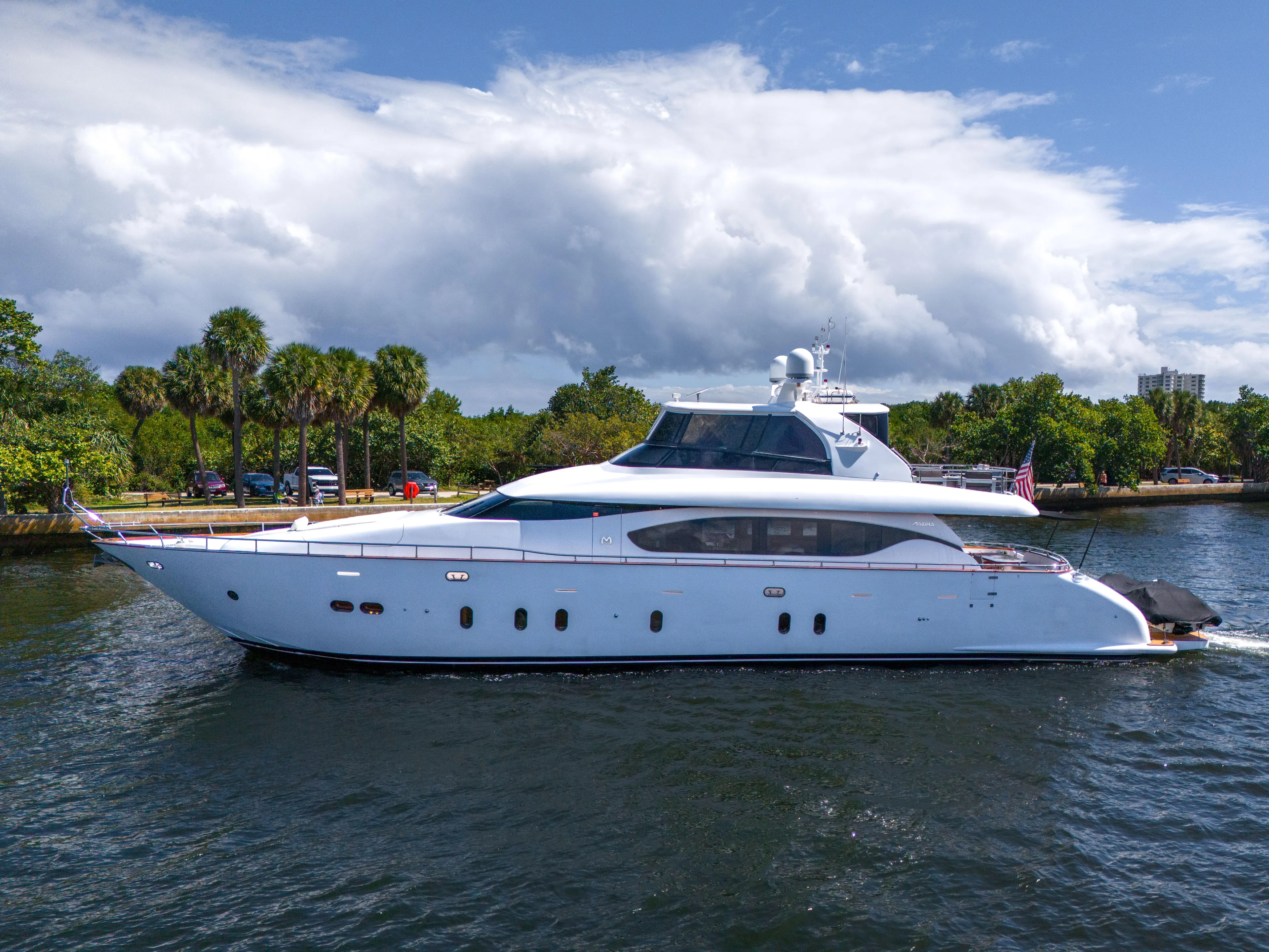  Yacht Photos Pics 2016 Maiora Custom yacht cruising on a scenic waterway with lush greenery.