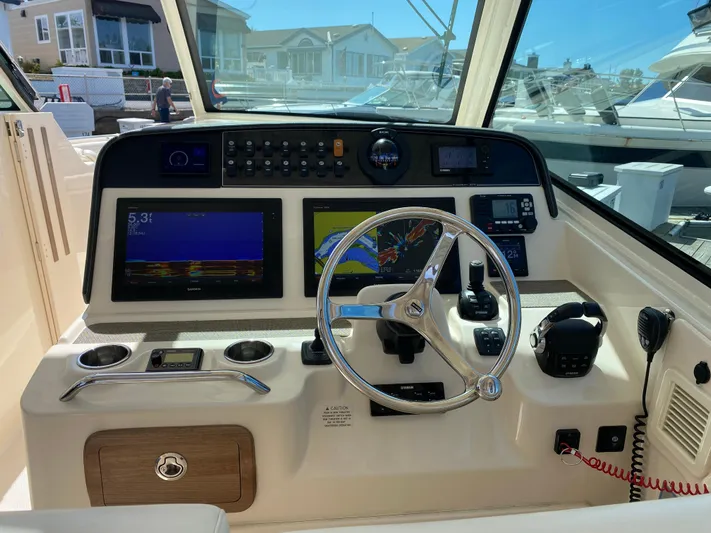 Lola Yacht Photos Pics 2017 Grady-White Freedom 375 helm with navigation screens and steering wheel.
