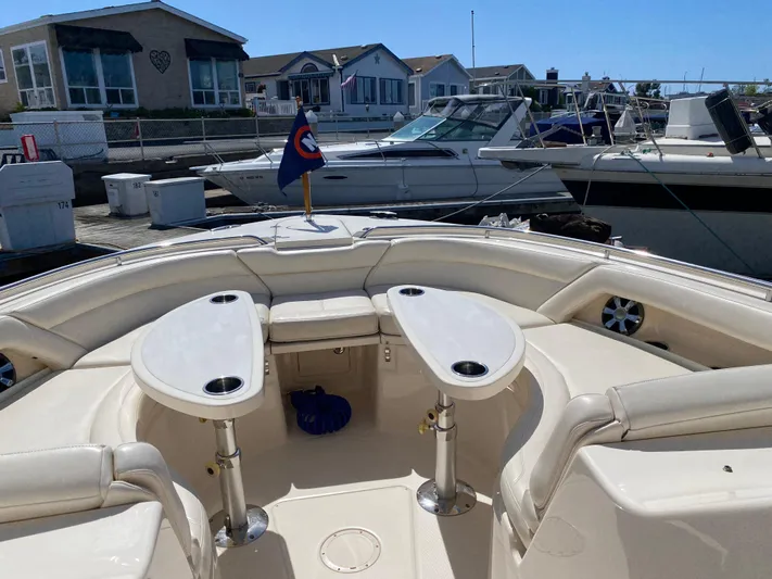 Lola Yacht Photos Pics 2017 Grady-White Freedom 375 boat with spacious seating and tables, docked at a marina.