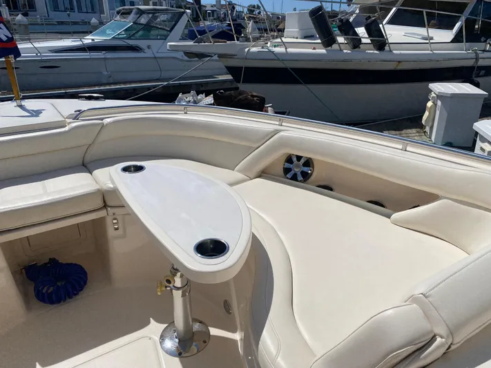 Lola Yacht Photos Pics 2017 Grady-White Freedom 375 boat interior with seating and table, docked at marina.