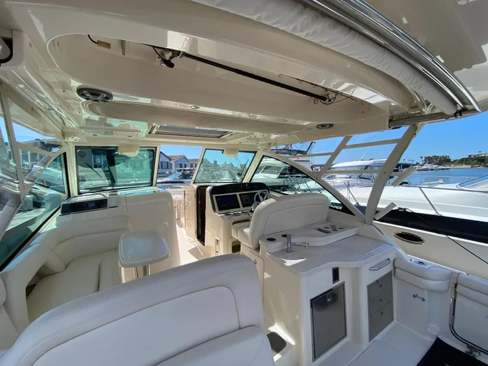 Lola Yacht Photos Pics 2017 Grady-White Freedom 375 boat interior with helm, seating, and marina view.