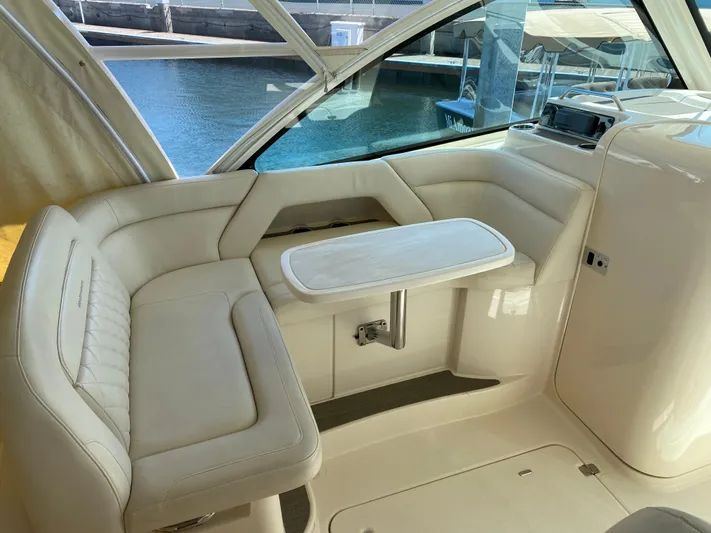 Lola Yacht Photos Pics 2017 Grady-White Freedom 375 boat interior with cushioned seating and table.