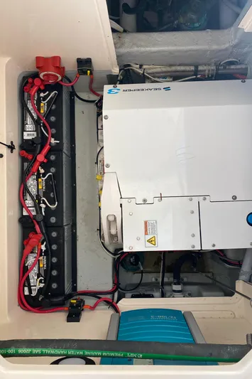 Lola Yacht Photos Pics Engine compartment of a 2017 Grady-White Freedom 375 boat, showing battery setup and electrical components.
