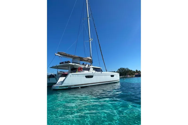 Nowhere Yacht Photos Pics 2016 Fountaine Pajot SABA 50 catamaran sailing in clear blue waters.
