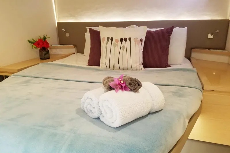 Nowhere Yacht Photos Pics Luxurious cabin interior of 2016 Fountaine Pajot SABA 50 with neatly arranged bed and towels.