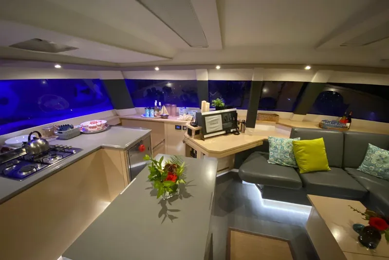 Nowhere Yacht Photos Pics Luxurious interior of 2016 Fountaine Pajot SABA 50 catamaran with modern kitchen and seating area.