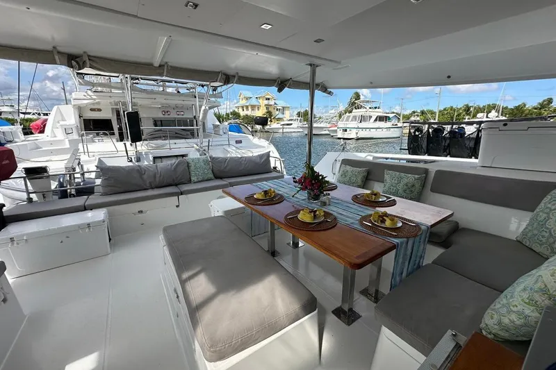 Nowhere Yacht Photos Pics Luxurious 2016 Fountaine Pajot SABA 50 yacht with elegant outdoor seating and dining area.
