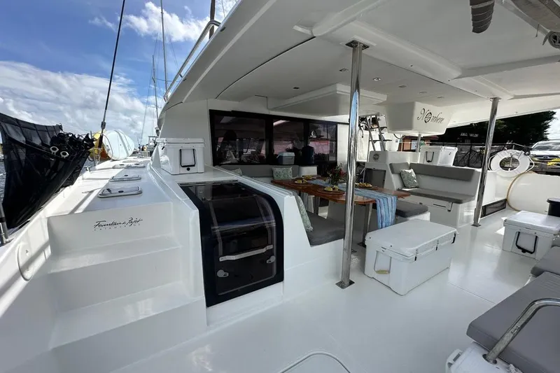 Nowhere Yacht Photos Pics 2016 Fountaine Pajot SABA 50 yacht deck with seating and dining area.