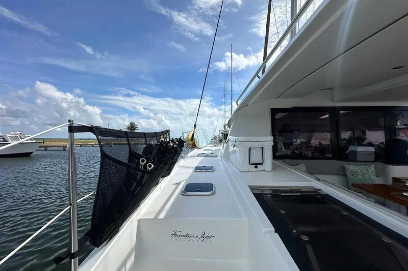 Nowhere Yacht Photos Pics 2016 Fountaine Pajot SABA 50 catamaran deck view with clear skies and marina backdrop.