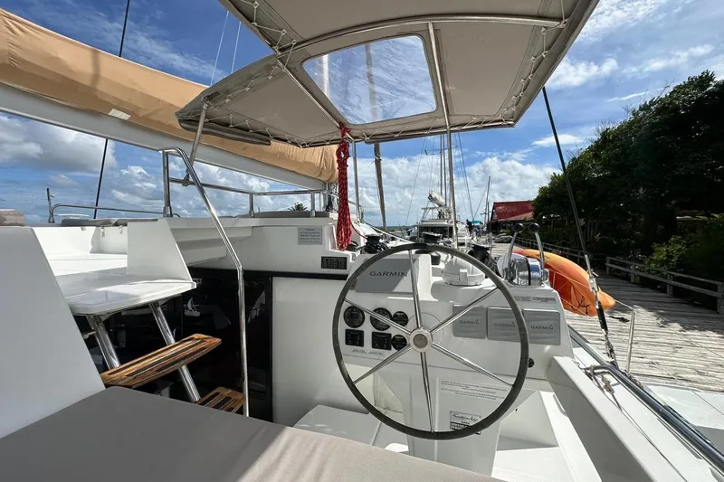 Nowhere Yacht Photos Pics Helm of 2016 Fountaine Pajot SABA 50 catamaran with Garmin navigation, docked under blue sky.