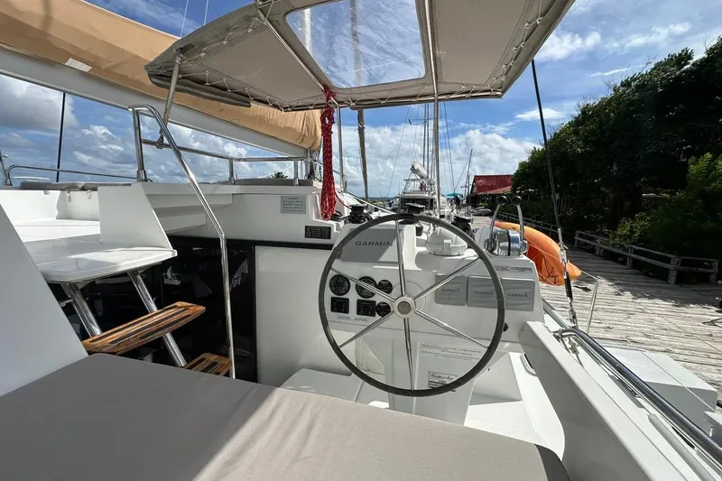 Nowhere Yacht Photos Pics Helm of 2016 Fountaine Pajot SABA 50 catamaran with Garmin navigation, docked under blue sky.