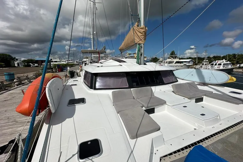 Nowhere Yacht Photos Pics 2016 Fountaine Pajot SABA 50 catamaran docked, featuring spacious deck and seating area.