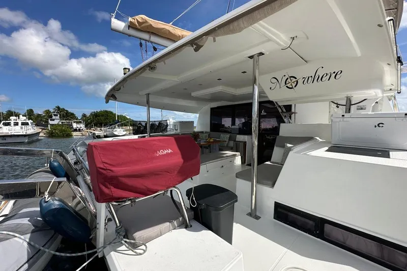 Nowhere Yacht Photos Pics 2016 Fountaine Pajot SABA 50 catamaran docked, featuring spacious deck and seating area.