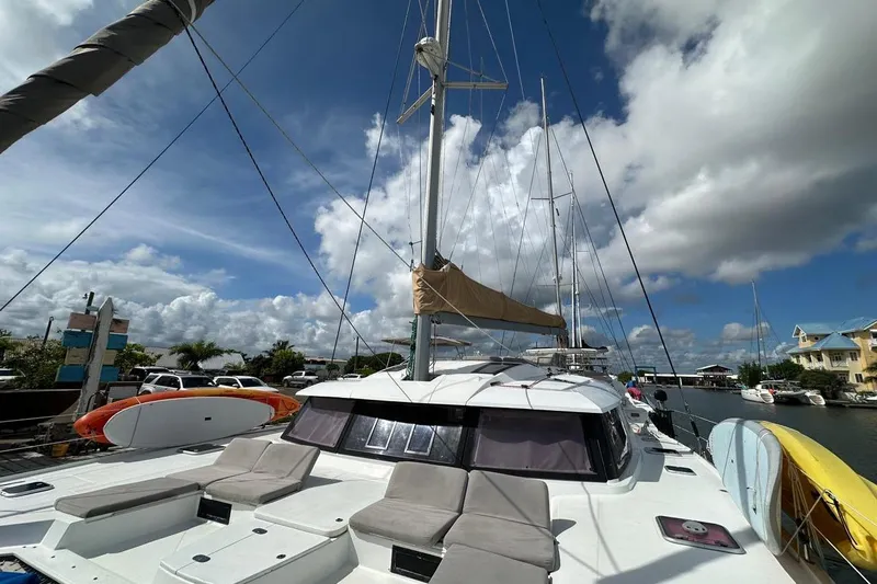 Nowhere Yacht Photos Pics 2016 Fountaine Pajot SABA 50 catamaran docked under a bright blue sky.