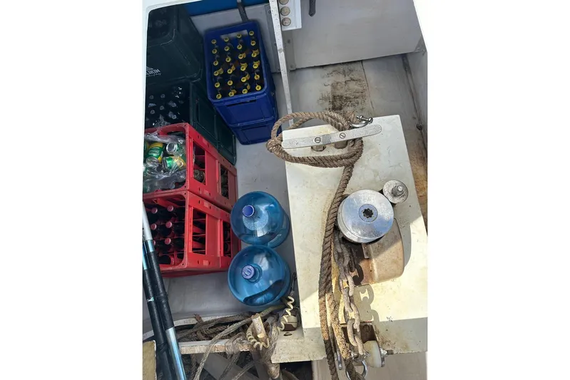 Nowhere Yacht Photos Pics Storage area on 2016 Fountaine Pajot SABA 50 with bottles, ropes, and equipment.