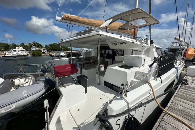 Nowhere Yacht Photos Pics 2016 Fountaine Pajot SABA 50 catamaran docked at marina under blue sky.