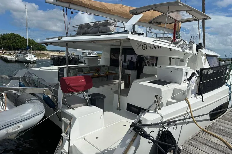 Nowhere Yacht Photos Pics 2016 Fountaine Pajot SABA 50 catamaran docked at marina, featuring spacious deck and equipment.