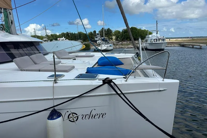 Nowhere Yacht Photos Pics 2016 Fountaine Pajot SABA 50 catamaran docked at marina, featuring spacious deck and seating.