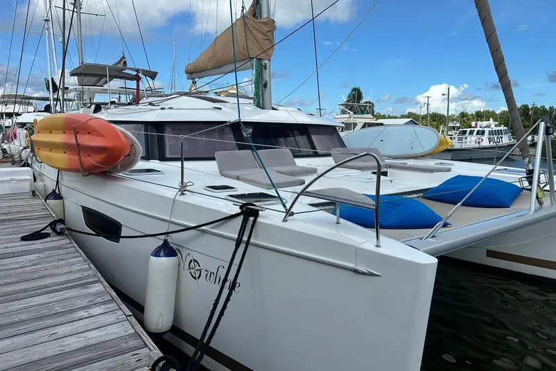 Nowhere Yacht Photos Pics 2016 Fountaine Pajot SABA 50 catamaran docked with kayaks and paddleboards on deck.