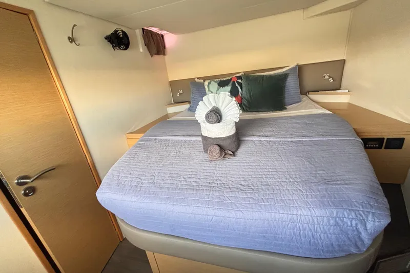 Nowhere Yacht Photos Pics Luxurious cabin interior of 2016 Fountaine Pajot SABA 50 catamaran with neatly arranged bed.