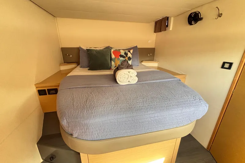 Nowhere Yacht Photos Pics Cozy bedroom in 2016 Fountaine Pajot SABA 50 yacht with neatly arranged bed and pillows.