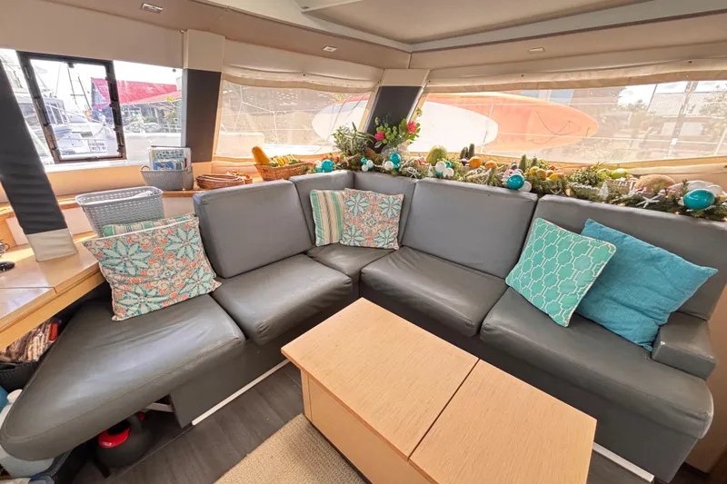 Nowhere Yacht Photos Pics Luxurious interior of 2016 Fountaine Pajot SABA 50 yacht with cozy seating and decorative pillows.