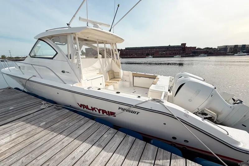  Yacht Photos Pics 2016 Pursuit OS 355 Offshore boat docked by the water, showcasing sleek design.