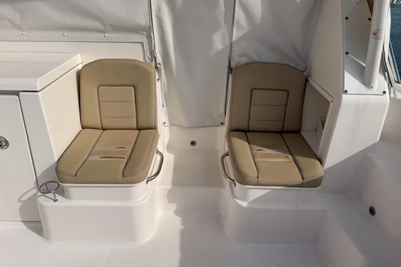  Yacht Photos Pics 2016 Pursuit OS 355 Offshore boat interior with beige seating and white accents.