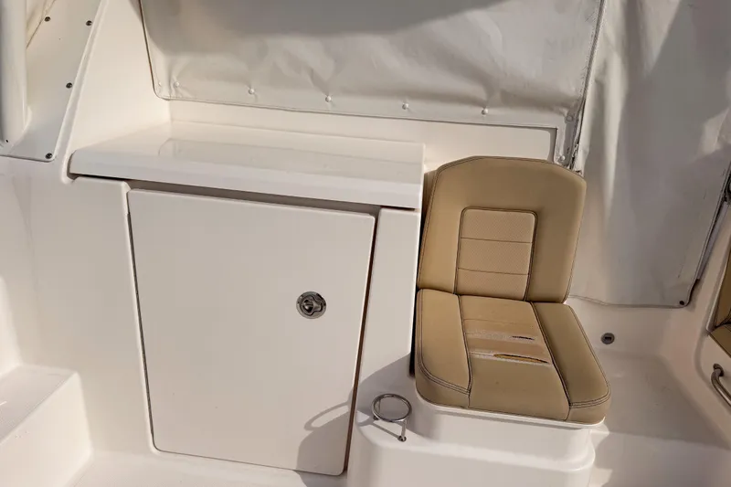  Yacht Photos Pics 2016 Pursuit OS 355 Offshore boat interior with beige seating and storage compartment.