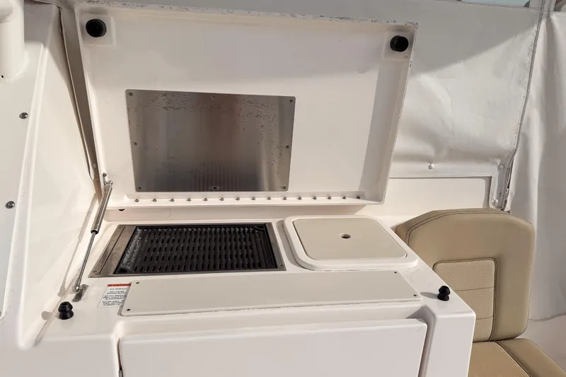  Yacht Photos Pics 2016 Pursuit OS 355 Offshore boat grill and sink area with beige seating.