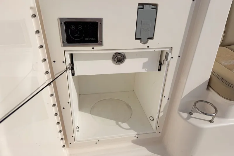  Yacht Photos Pics 2016 Pursuit OS 355 Offshore storage compartment with control panel and cup holder.