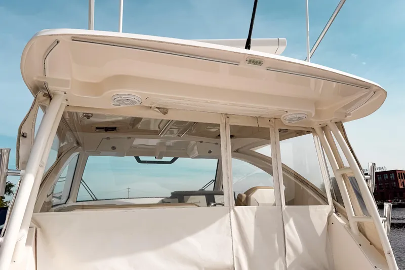  Yacht Photos Pics 2016 Pursuit OS 355 Offshore boat with covered cockpit and clear skies.