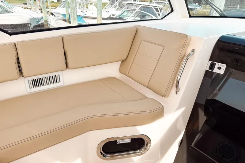  Yacht Photos Pics 2016 Pursuit OS 355 Offshore boat interior with beige seating and window view.