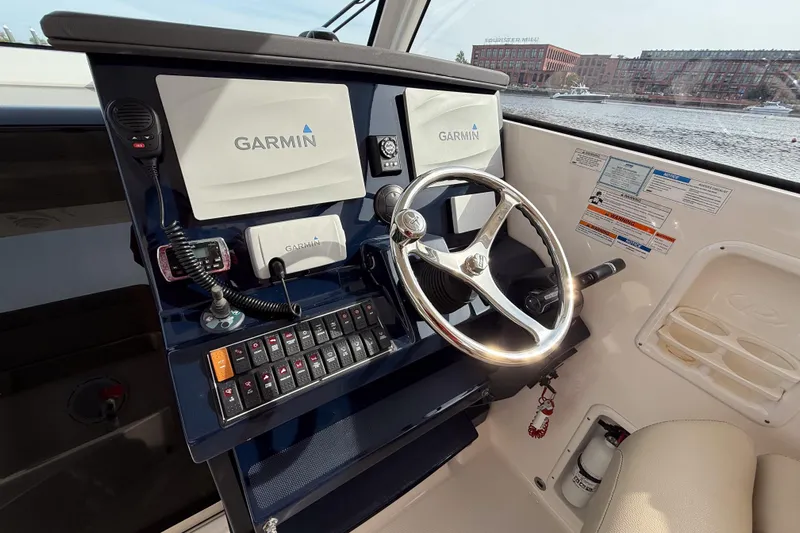  Yacht Photos Pics 2016 Pursuit OS 355 Offshore helm with Garmin navigation system and steering wheel.