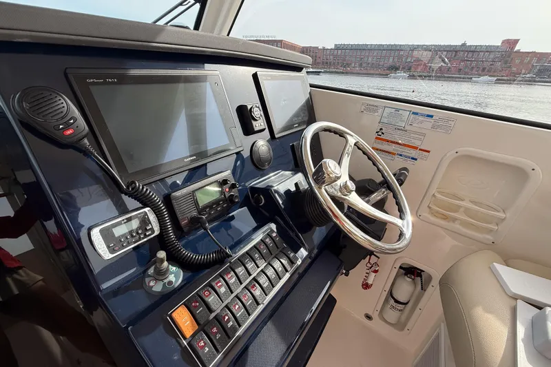  Yacht Photos Pics Cockpit of 2016 Pursuit OS 355 Offshore boat with navigation equipment and steering wheel.