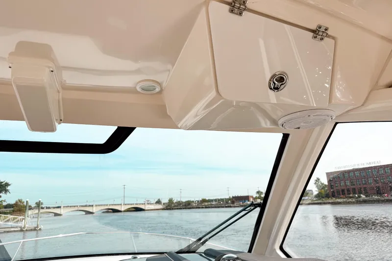  Yacht Photos Pics Interior view of 2016 Pursuit OS 355 Offshore boat with waterway and bridge in background.