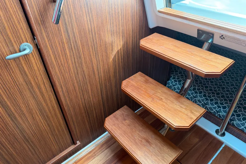  Yacht Photos Pics Wooden interior stairs on a 2016 Pursuit OS 355 Offshore boat.
